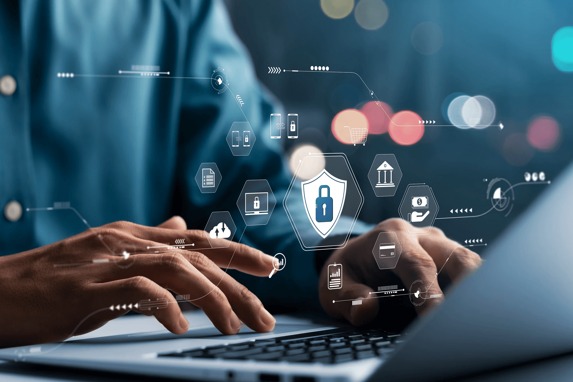 Professional working on a laptop with digital security graphics